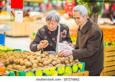 Senior Man And Woman Shopping Fruit. A  Senior Couple, 80 Years Old, Is Selecting Fruits In A Supermarket.