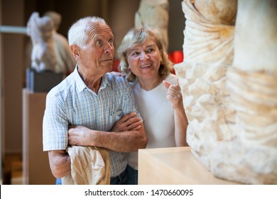 Senior Man And Woman Visiting Exposition Of Museum With Exhibits Of Art