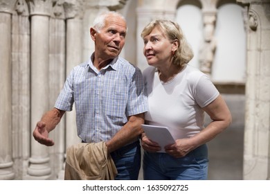 Senior Man And Woman Visiting Exposition Of Museum With Exhibits Of Art