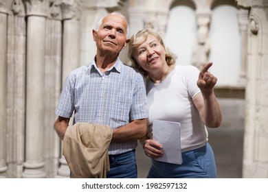 Senior Man And Woman Visiting Exposition Of Museum With Exhibits Of Art