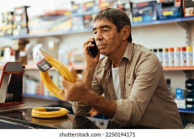 Senior man working at his hardware store. Small business concept. - Shutterstock ID 2250194171