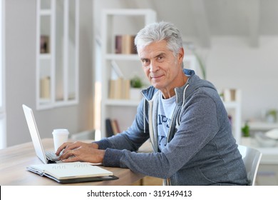 Senior man working from home on laptop computer