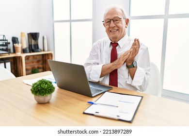 Senior Man Working At The Office Using Computer Laptop Clapping And Applauding Happy And Joyful, Smiling Proud Hands Together 