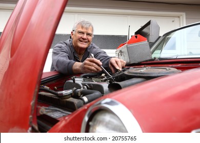 Senior Man Working On Classic Car