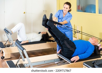 Senior Man Workout In Rehabilitation Center. Personal Trainer Helping Senior Man