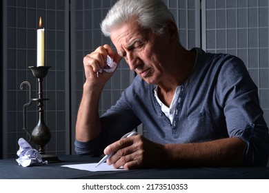 Senior Man Writing A Letter At Home