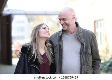 Senior Man And Young Woman Look In Love