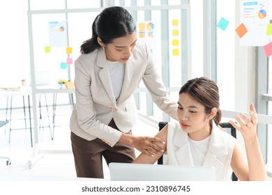 Senior manager helps her colleague who has depressed or unwell in working at the office - Powered by Shutterstock