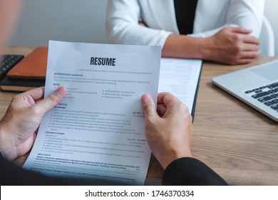 Senior manager HR reading a resume during a job interview employee young man meeting Applicant and recruitment - Shutterstock ID 1746370334