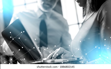 Senior manager working with executive assistant in office; light effect - Shutterstock ID 1886802145