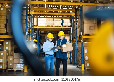 Senior managers or supervisors with tablet working in a warehouse, controlling stock. - Powered by Shutterstock