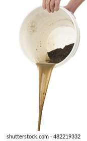 A Senior Man's Hands Holding A White Bucket As He Dumps Out Dirty Water. On A White Background.