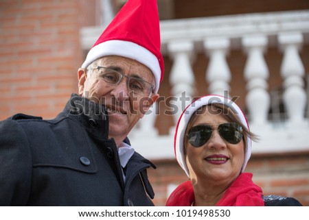 senior married couple pose with a pope noel cap in the garden of their home Foto stock © 
