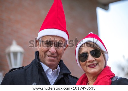 senior married couple pose with a pope noel cap in the garden of their home Foto stock © 