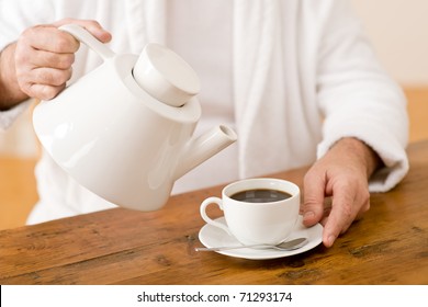 Senior mature man pour coffee wear bathrobe - Powered by Shutterstock