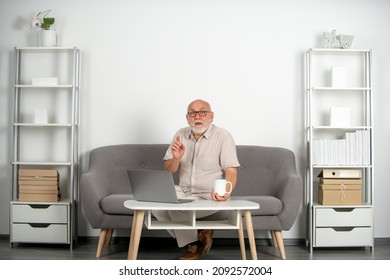 Senior Mature Older Man Watching Business Training, Online Webinar On Laptop Computer, Remote Working. Aged Businessman On Video Conference Calling In Virtual Chat.