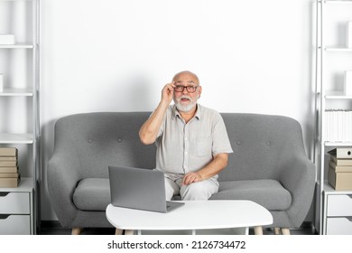 Senior Mature Older Man Watching Business Training, Online Webinar On Laptop Computer, Remote Working. Senior Social Worker, Psychologist.