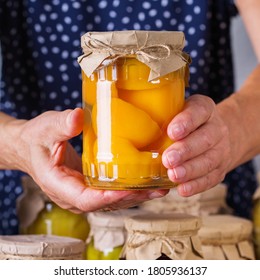 Senior mature woman holding in hands jar with homemade preserved and fermented food. Variety of pickled and marinated vegetables, fruit compote. Housekeeping, home economics, harvest preservation   - Powered by Shutterstock