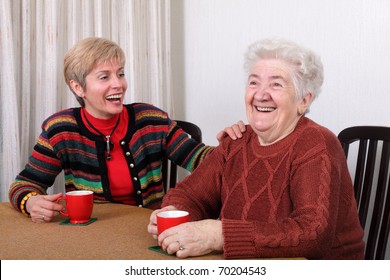 Senior And Mature Womans Drinking Caffee And Laughing