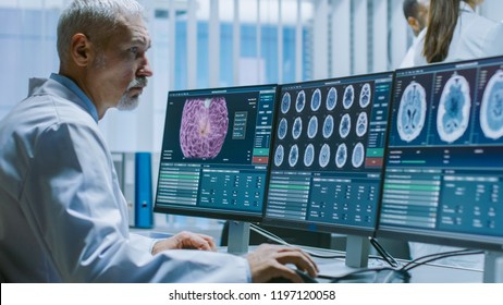 Senior Medical Research Scientist Working with Brain Scans on His Personal Computer. Modern Laboratory Working on Neurophysiology, Science,  Neuropharmacology. Understanding Human Brain.