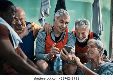 Senior men laughing with smartphone in locker room - Powered by Shutterstock