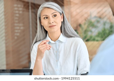 Senior Middle Aged Asian Business Woman Training Listening Young Intern Trainee For Professional Skills At Group Meeting In Modern Office. Mid Age Older Teacher With Group Of Students On Seminar.