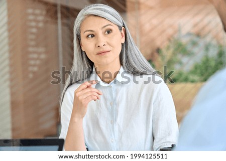 Similar – Image, Stock Photo Young adult asian female wearing glasses in front of neon light sign, shallow selective focus