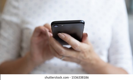 Senior Middle Aged Woman Holding Modern Device Smart Phone Using Mobile App, Old Elderly Person Female Hands Typing Texting Message Online On Cellphone, Older People And Tech Concept, Close Up View