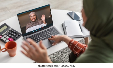 Senior Middle-Eastern Lady Using Laptop Video Calling Daughter At Home. Modern Muslim Family Communicating Online. Selective Focus On Computer. Panorama, Back View, Collage