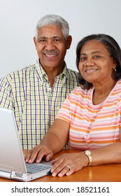 Senior Minority Couple Working On A Computer