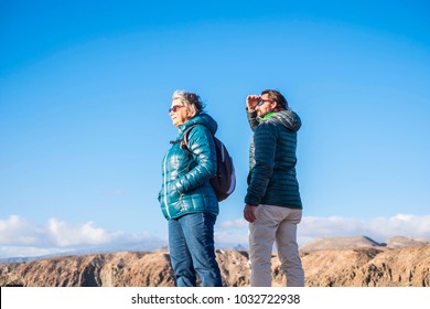 Senior Mother And 45 Year Old Son Spend Good Time Together Hiking And Observing The Beauty That Surrounds Them