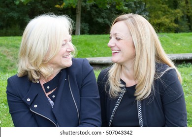 Senior Mother With Adult Daughter And Affectionately Talking