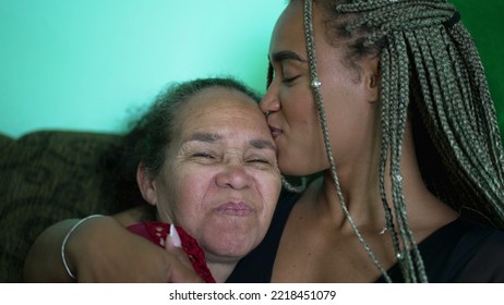 Senior Mother And Daughter Love And Care. A Black Latina Family Kiss