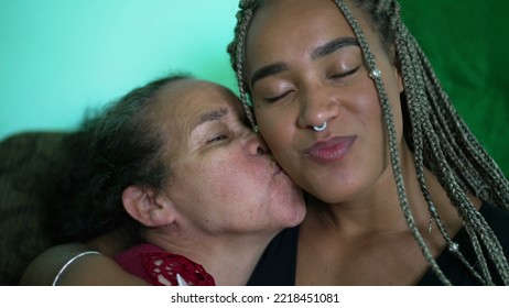 Senior Mother And Daughter Love And Care. A Black Latina Family Kiss