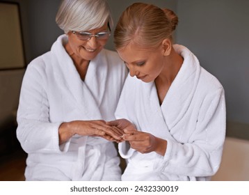 Senior mother, woman and manicure at home, cosmetics and spa for bonding and relaxation. Parent, daughter and nail polish with bath, guidance and support with beauty treatment or makeup with robe - Powered by Shutterstock