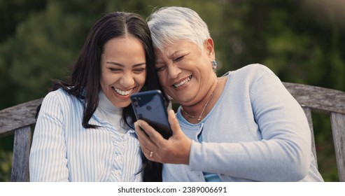 Senior, mother and woman with smartphone on bench, nature and laughing for social media meme on retirement. Mature parent, older daughter and technology in park for online comedy and love in garden - Powered by Shutterstock