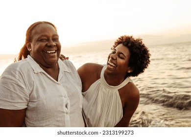 Senior mother and young daugther together on the beach. - Powered by Shutterstock