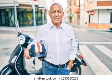 Senior Motorcyclist Man Smiling Happy Holding Moto Helmet At The City.