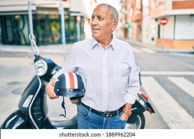 Senior Motorcyclist Man Smiling Happy Holding Moto Helmet At The City.