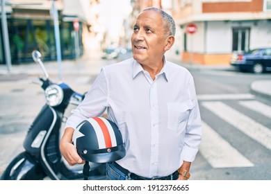 Senior Motorcyclist Man Smiling Happy Holding Moto Helmet At The City.