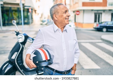 Senior Motorcyclist Man Smiling Happy Holding Moto Helmet At The City.