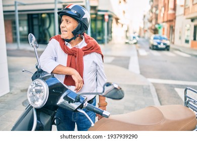 Senior Motorcyclist Man Smiling Happy Wearing Moto Helmet At The City.