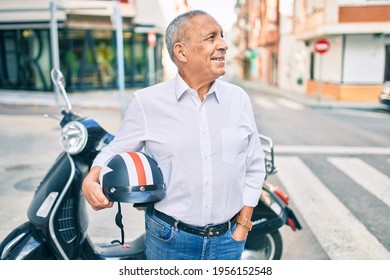 Senior Motorcyclist Man Smiling Happy Holding Moto Helmet At The City.