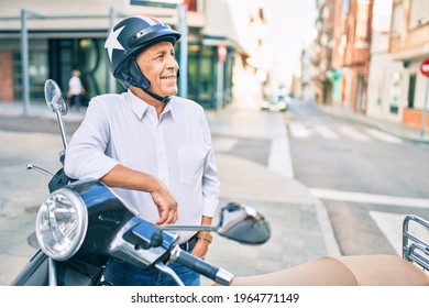 Senior Motorcyclist Man Smiling Happy Wearing Moto Helmet At The City.