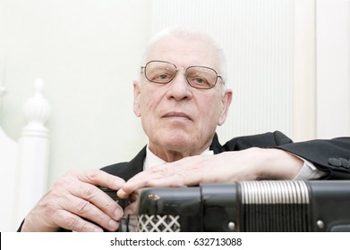 Senior Musician Posing With Harmonica, Indoor Cropped Portrait