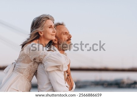 Similar – Image, Stock Photo Happy stylish couple newlyweds in the green forest on summer day. bride in long white dress and groom in red suit are hugging. wedding day