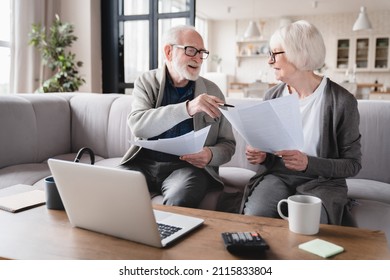 Senior old elderly grandparents couple family wife and husband counting funds, savings declarations, investments,paperwork, financial documents, bankruptcy, court case, bills, pension with laptop.