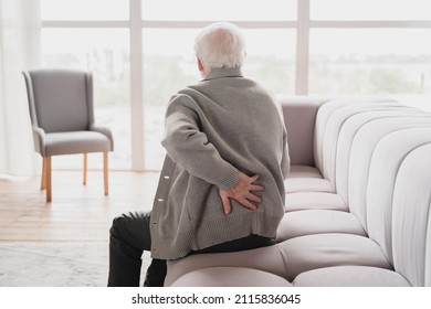 Senior old elderly man grandfather touching his back, suffering from backpain, sciatica, sedentary lifestyle concept. Spine health problems. Healthcare, insurance - Shutterstock ID 2115836045