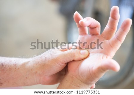 Senior old man having problem trigger finger.Hand trigger finger lock concept healthy.