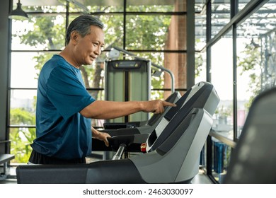 Senior old man runner exercise indoor gym. fitness man jogging wearing sportswear. Mature athlete man in sportswear Workout running on the treadmill. - Powered by Shutterstock